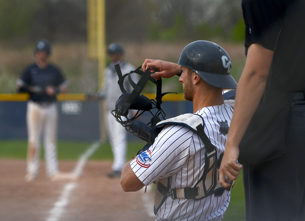 Catcher Kenny Piper adjusts his helmet